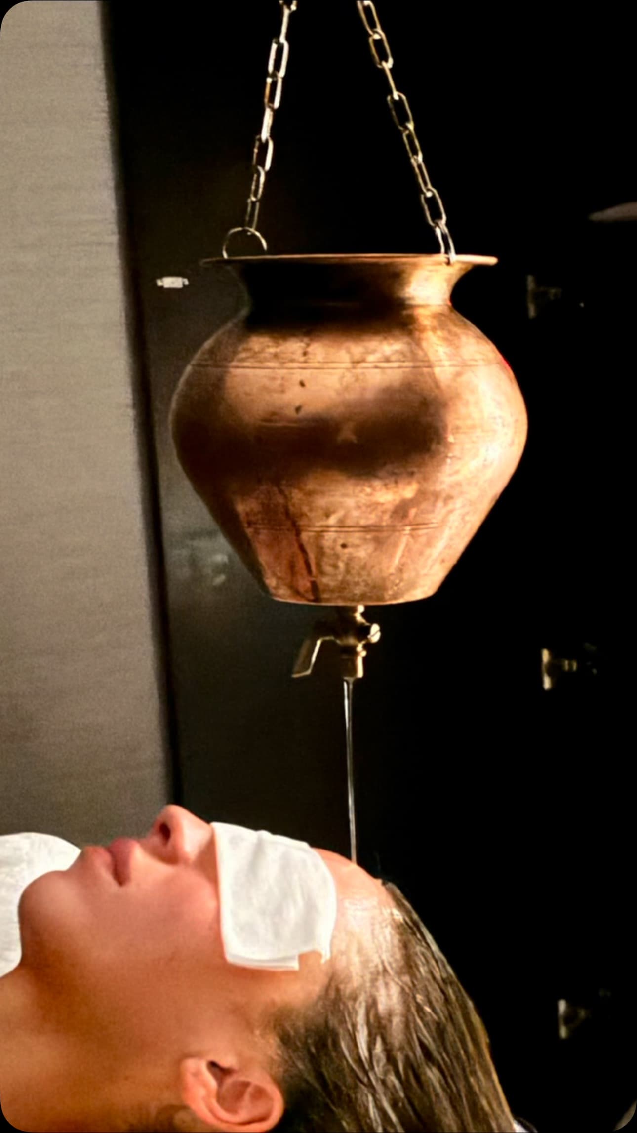 Shirodhara Ayurvedic oil treatment with copper vessel